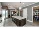 Bright kitchen featuring a dark island with a white countertop, stainless steel appliances, and an eat-in area at 331 Wages Rd, Auburn, GA 30011