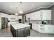 Spacious kitchen with stainless steel appliances, white cabinets and gray island with white countertop at 331 Wages Rd, Auburn, GA 30011