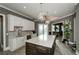 Open kitchen features a gray island with white countertop, stainless steel appliances, and an eat-in area at 331 Wages Rd, Auburn, GA 30011