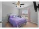 Spacious bedroom with a purple comforter and ceiling fan at 3725 Elder Field Ln, Cumming, GA 30040