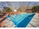 Sparkling backyard swimming pool is surrounded by mature trees and a spacious deck at 50 Dogwood Ln, Covington, GA 30014