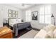 Bright bedroom with a metal bed frame, white bedding, and a sitting area at 9060 Selborne Ln, Chattahoochee Hills, GA 30268