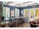 Basement dining area with a rustic table, chairs, and access to patio at 9060 Selborne Ln, Chattahoochee Hills, GA 30268