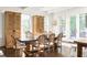 Bright dining room featuring a large table, chairs, and built-in cabinets at 9060 Selborne Ln, Chattahoochee Hills, GA 30268