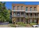 Brick townhome with multiple levels, balconies, and a charming street view at 9060 Selborne Ln, Chattahoochee Hills, GA 30268