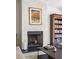 Elegant fireplace with white brick surround and dark mantel at 9060 Selborne Ln, Chattahoochee Hills, GA 30268