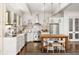 White kitchen with stainless steel appliances and wood island at 9060 Selborne Ln, Chattahoochee Hills, GA 30268