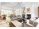Open living room with hardwood floors and views into the kitchen at 9060 Selborne Ln, Chattahoochee Hills, GA 30268