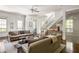 Bright living room featuring hardwood floors and access to a balcony at 9060 Selborne Ln, Chattahoochee Hills, GA 30268