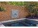 Private pool with brick wall and ornate wall fountain at 9060 Selborne Ln, Chattahoochee Hills, GA 30268