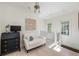 Upstairs sitting room with a sofa, writing desk, and balcony view at 9060 Selborne Ln, Chattahoochee Hills, GA 30268