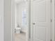 Bright half bath featuring a toilet and small window with blinds at 4235 Holland Grove Rd, Lawrenceville, GA 30044