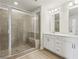 Bathroom showcasing a glass-door shower with a built-in bench and a double vanity at 4235 Holland Grove Rd, Lawrenceville, GA 30044