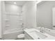Well-lit bathroom features a tub-shower combination, large mirror, and vanity sink at 4235 Holland Grove Rd, Lawrenceville, GA 30044