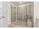 Glass door shower in bathroom with tile surround at 4235 Holland Grove Rd, Lawrenceville, GA 30044