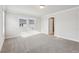 Neutral carpeted bedroom with large open space and natural lighting at 4235 Holland Grove Rd, Lawrenceville, GA 30044
