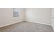 Bright, carpeted bedroom with a window and closet at 4235 Holland Grove Rd, Lawrenceville, GA 30044