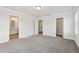 Neutral carpeted bedroom with large open space and multiple doorways at 4235 Holland Grove Rd, Lawrenceville, GA 30044