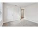 Neutral bedroom featuring a large closet and neutral carpet at 4235 Holland Grove Rd, Lawrenceville, GA 30044