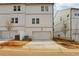 New construction townhome featuring white siding, garage, and landscaping at 4235 Holland Grove Rd, Lawrenceville, GA 30044