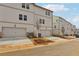 New construction townhome featuring white siding, garage, and landscaping at 4235 Holland Grove Rd, Lawrenceville, GA 30044
