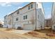 New construction townhome featuring white siding, garage, and landscaping at 4235 Holland Grove Rd, Lawrenceville, GA 30044