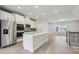 Modern kitchen with stainless steel appliances, white cabinetry, and a large center island at 4235 Holland Grove Rd, Lawrenceville, GA 30044