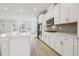 Modern kitchen featuring white cabinetry, stainless steel appliances, and a light backsplash at 4235 Holland Grove Rd, Lawrenceville, GA 30044