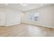 Spacious living room features wood floors, a large window, neutral walls, and recessed lighting at 4235 Holland Grove Rd, Lawrenceville, GA 30044