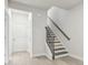 Bright, modern staircase with wood and iron accents leads to the upper level at 4235 Holland Grove Rd, Lawrenceville, GA 30044