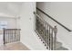 Carpeted staircase with decorative wooden railing and black iron balusters in a bright home at 4235 Holland Grove Rd, Lawrenceville, GA 30044