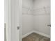 Spacious walk-in closet with built in shelving and neutral carpet at 4235 Holland Grove Rd, Lawrenceville, GA 30044