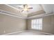 Spacious bedroom with tray ceiling and ceiling fan at 1685 Terrace Lake Dr, Lawrenceville, GA 30043