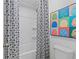 Small bathroom with shower/tub combo, shelf, and patterned shower curtain at 329 Delta Dr, Mcdonough, GA 30253