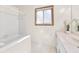 Clean bathroom with tub, vanity and window at 778 Villa Way, Jonesboro, GA 30238