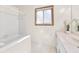 Clean bathroom with tub, vanity, and window at 778 Villa Way, Jonesboro, GA 30238