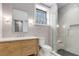 Well-lit bathroom with a modern vanity, toilet, and glass-enclosed shower at 110 Maryeanna Ne Dr, Atlanta, GA 30342