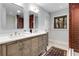 Elegant bathroom featuring double sinks, and a modern brick-look tile shower at 110 Maryeanna Ne Dr, Atlanta, GA 30342