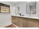 Bathroom boasting a dual sink vanity, sleek mirrors, and stylish lighting fixtures at 110 Maryeanna Ne Dr, Atlanta, GA 30342