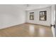 Bright bedroom with hardwood floors, two windows, and a ceiling fan at 110 Maryeanna Ne Dr, Atlanta, GA 30342