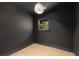 Cozy room featuring dark walls, hardwood floors, a window, and a stylish chandelier at 110 Maryeanna Ne Dr, Atlanta, GA 30342