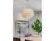 Modern dining room chandelier and greenery add to the ambiance of this well-lit dining area at 110 Maryeanna Ne Dr, Atlanta, GA 30342