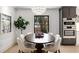 Contemporary dining room with a round table, stylish chairs, and natural light from a large window at 110 Maryeanna Ne Dr, Atlanta, GA 30342