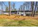 Charming two-story home featuring a landscaped yard with mature trees and a combination of brick and siding at 110 Maryeanna Ne Dr, Atlanta, GA 30342