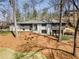 Beautiful home exterior showcasing the meticulously maintained lawn and mature trees surrounding the property at 110 Maryeanna Ne Dr, Atlanta, GA 30342