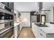 Modern kitchen with stainless steel appliances, gas cooktop, and white cabinets near a black door at 110 Maryeanna Ne Dr, Atlanta, GA 30342