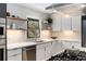 Bright kitchen with white cabinets, stainless steel appliances, open shelving, and gas cooktop at 110 Maryeanna Ne Dr, Atlanta, GA 30342