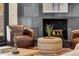 The seating area showcases leather chairs, a slate fireplace, and a woven ottoman in a cozy living space at 110 Maryeanna Ne Dr, Atlanta, GA 30342
