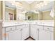 Bright bathroom with double sinks, white cabinets, and decorative light fixtures at 560 Dutch Valley Ne Rd # 209, Atlanta, GA 30324