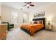 Comfortable bedroom with natural light, a ceiling fan, and a tufted headboard bed at 560 Dutch Valley Ne Rd # 209, Atlanta, GA 30324